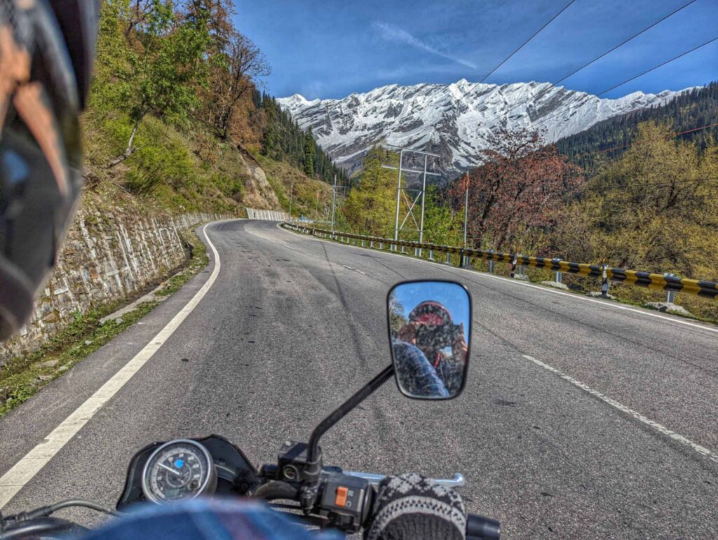 Roads of Kullu valley where every turn offers a glimpse of nature's charm amidst lush greenery and majestic mountains.