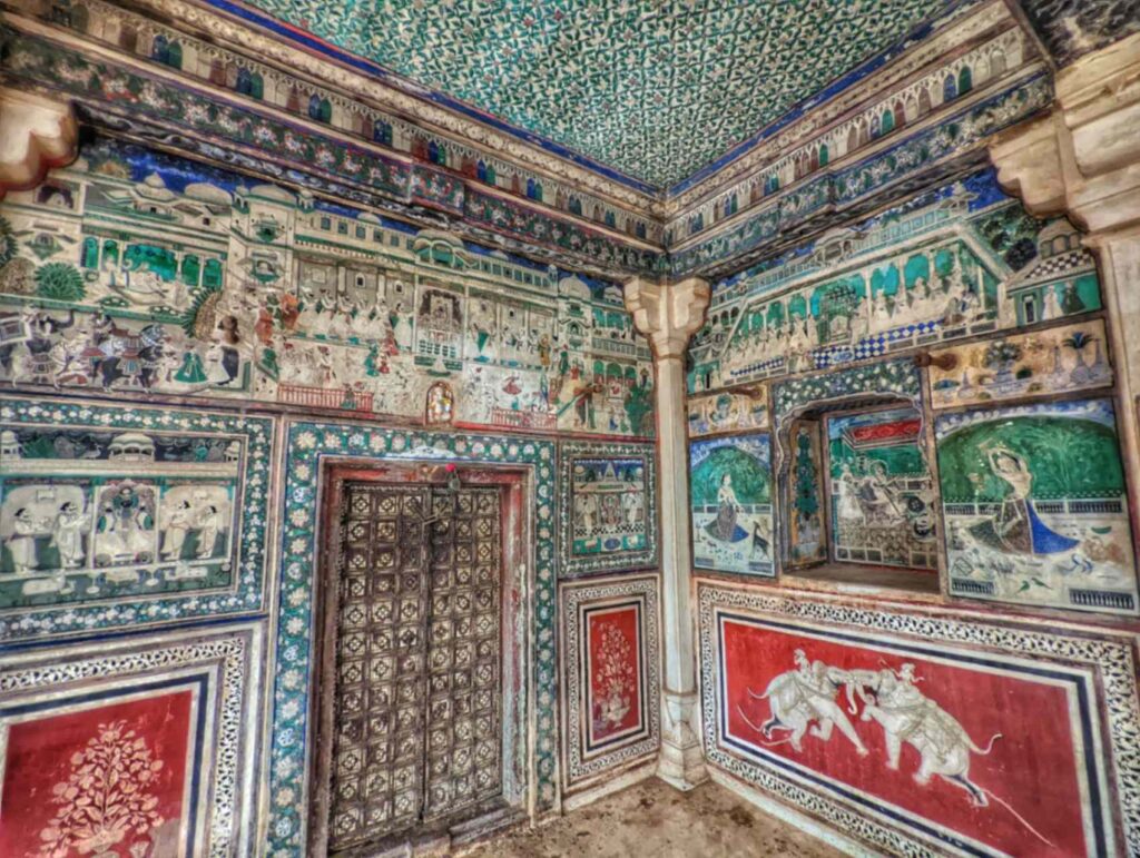 Detailed frescoes in Bundi Chitrashala, Rajasthan, featuring vibrant depictions of mythological stories, courtly scenes, and nature motifs, exemplifying the artistic finesse of Bundi's traditional painting style.