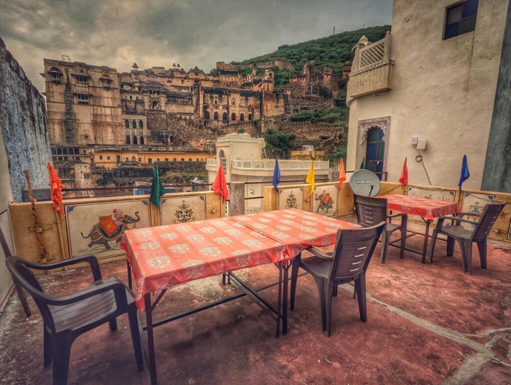 Rooftop restaurant at Palace View Homestay in Bundi, offering stunning views of Bundi Palace and the surrounding cityscape, creating a serene dining experience.
