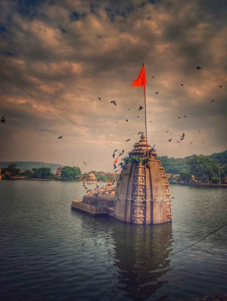 "Half-submerged Varuna Temple in Navalsagar Lake, Bundi, Rajasthan, with its striking reflection on the water, showcasing its architectural beauty and spiritual significance."