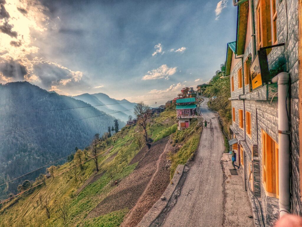 A cozy and vibrant hostel in Shoja, surrounded by lush Himalayan forests and offering panoramic views of snow-capped mountains, perfect for backpackers and nature enthusiasts.