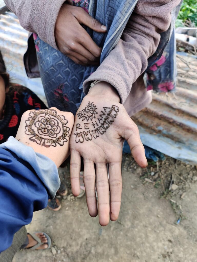 Heartfelt interaction with Kashmiri nomadic tribes during the Kashmir Great Lakes Trek. A local girl lovingly drew Mehendi (Henna) on my hand, and in return, I adorned her hand with Mehendi featuring her name. A beautiful cultural exchange captured in this moment."