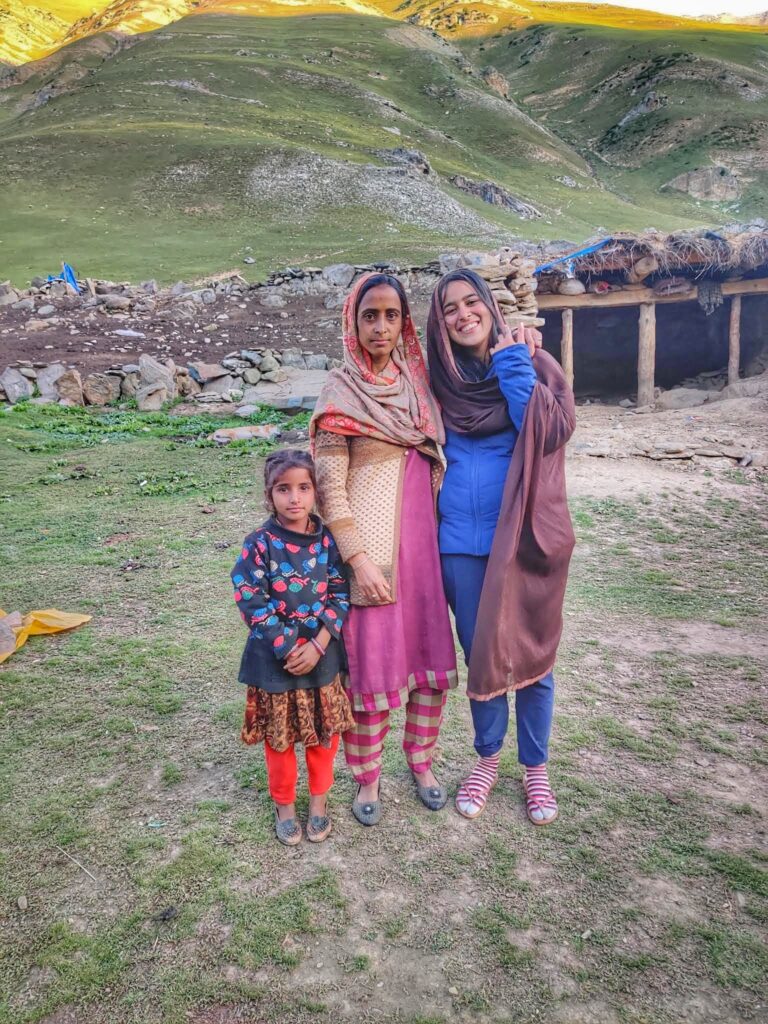 A heartwarming moment on the Kashmir Great Lakes trek, where a nomad family invited me into their home, seen in the background, and lovingly gave me a traditional shawl to wear.