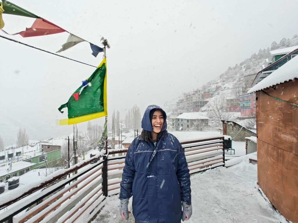 Enjoying the magical snowfall in Lahaul Valley, surrounded by snow-covered landscapes and breathtaking Himalayan scenery.