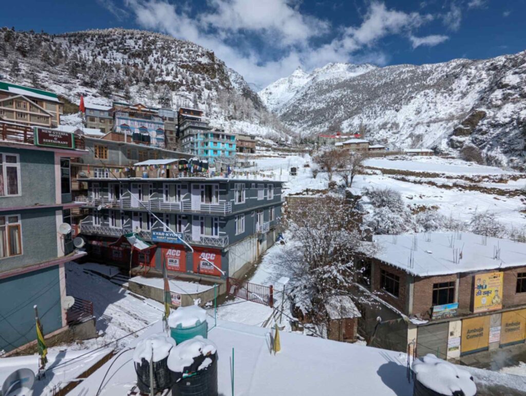 "Snow-covered landscape in Keylong, Lahaul Valley, Himachal Pradesh, featuring majestic mountains, white-capped peaks, and a serene winter atmosphere."