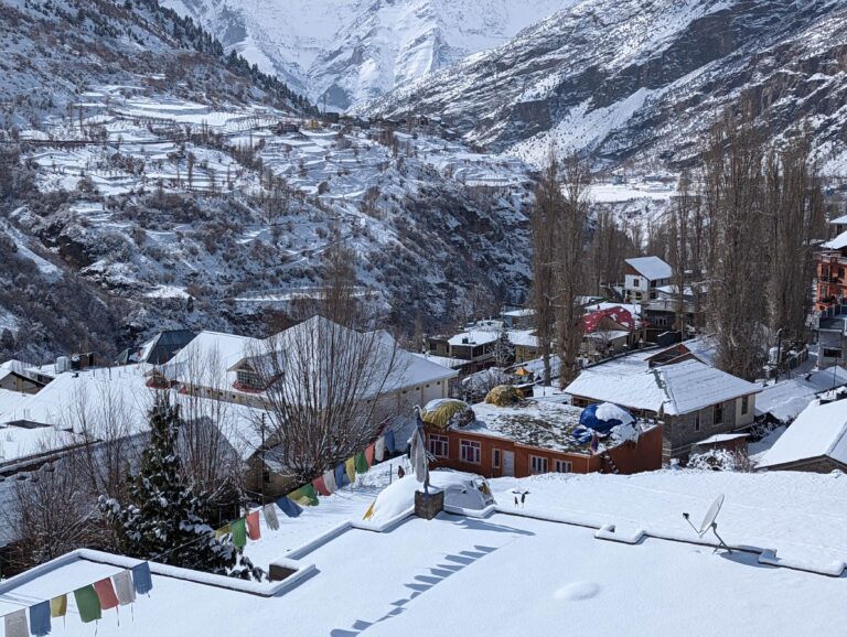 Snow-covered landscape in Keylong, Lahaul Valley, Himachal Pradesh, featuring majestic mountains, white-capped peaks, and a serene winter atmosphere.