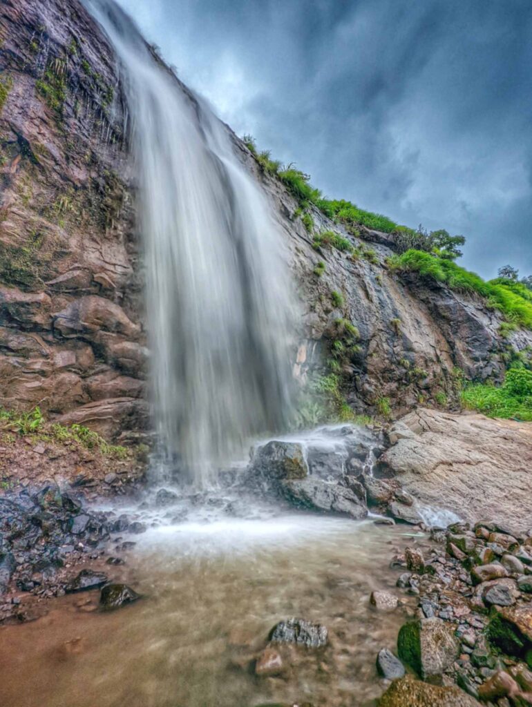 Stunning long exposure shot of a waterfall in Khandi, Maval – Smooth, silky cascades flowing through lush green landscapes in the serene Western Ghats.
