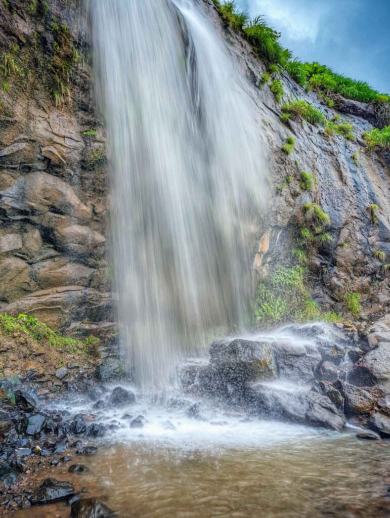 Stunning long exposure shot of a waterfall in Khandi, Maval – Smooth, silky cascades flowing through lush green landscapes in the serene Western Ghats.