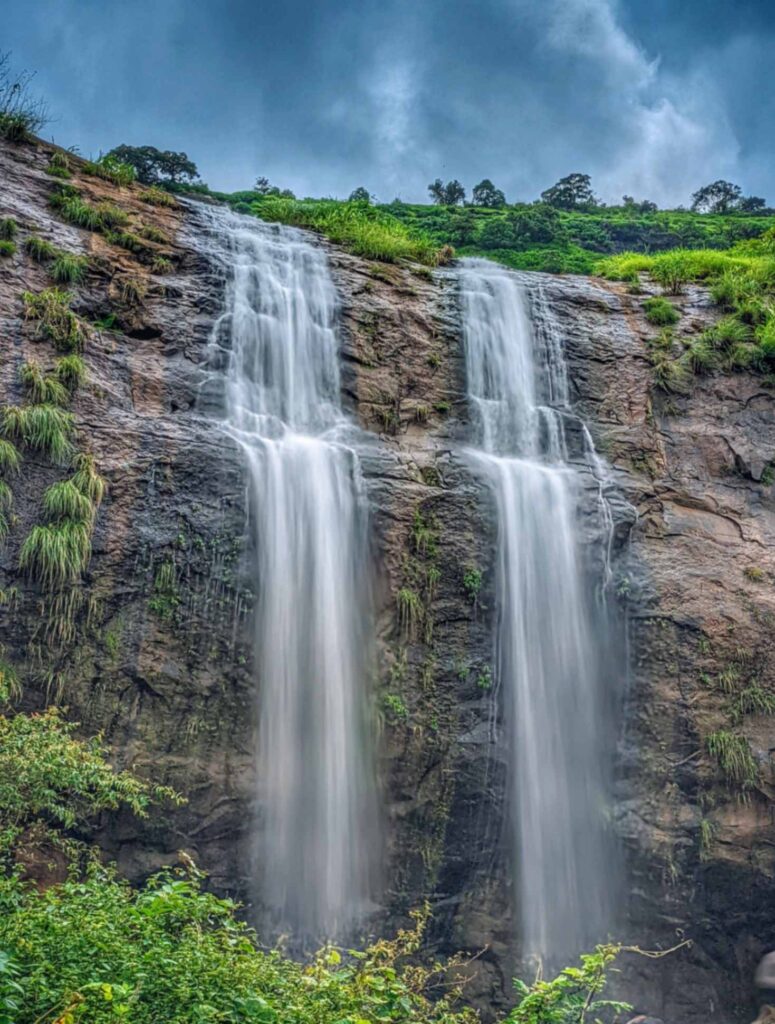 Stunning long exposure shot of a waterfall in Khandi, Maval – Smooth, silky cascades flowing through lush green landscapes in the serene Western Ghats.