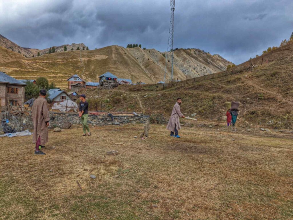Men playing cricket in mountains of Tulail valley, Kashmir