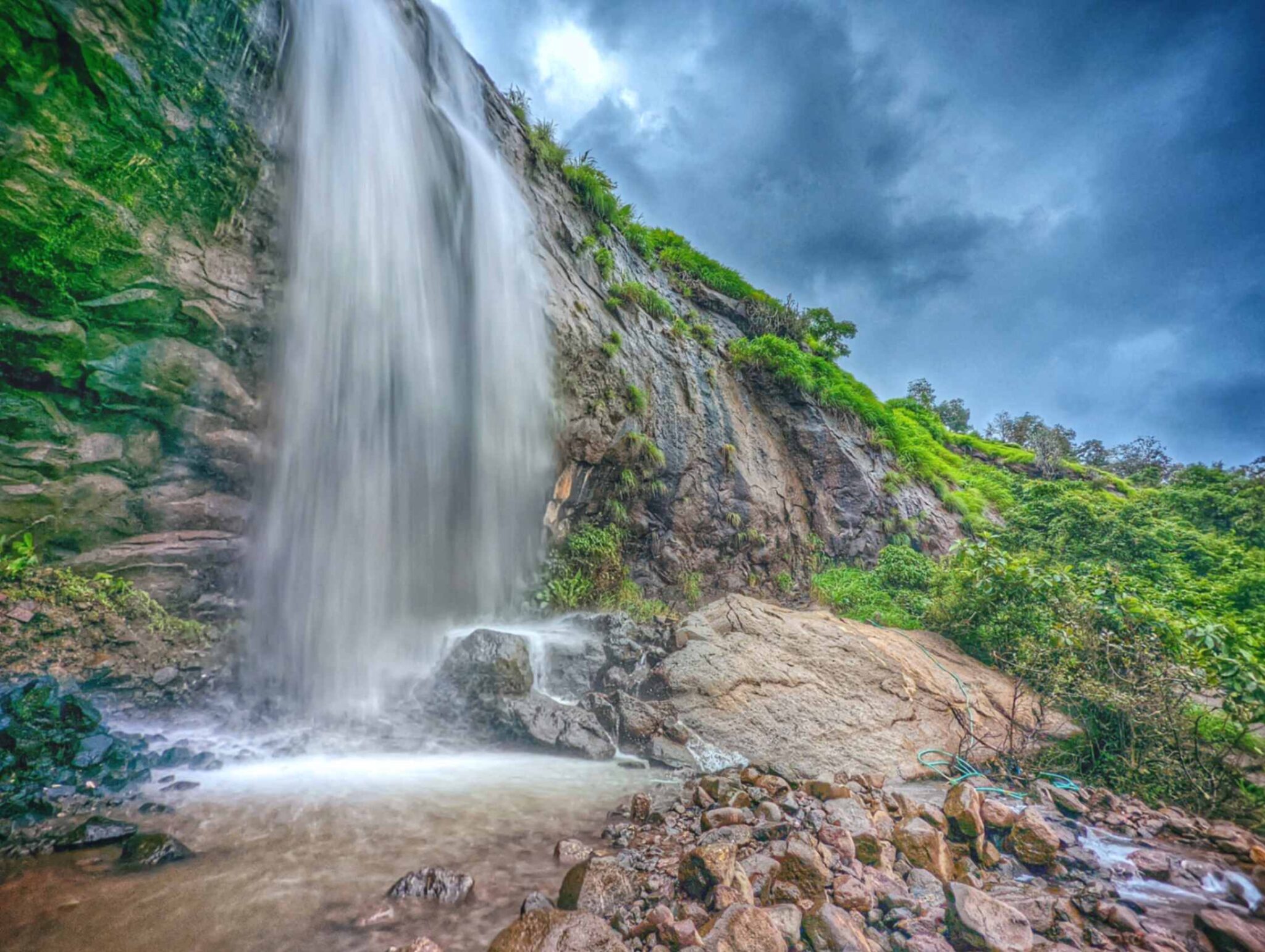 Scenic waterfall in Khandi region, Maval – Lush greenery and cascading water in a serene natural setting