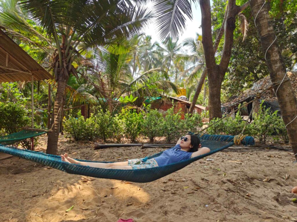 Chilling in the hammock under coconut trees at Aapa's Coconut garden homestay, Talashil, Malvan